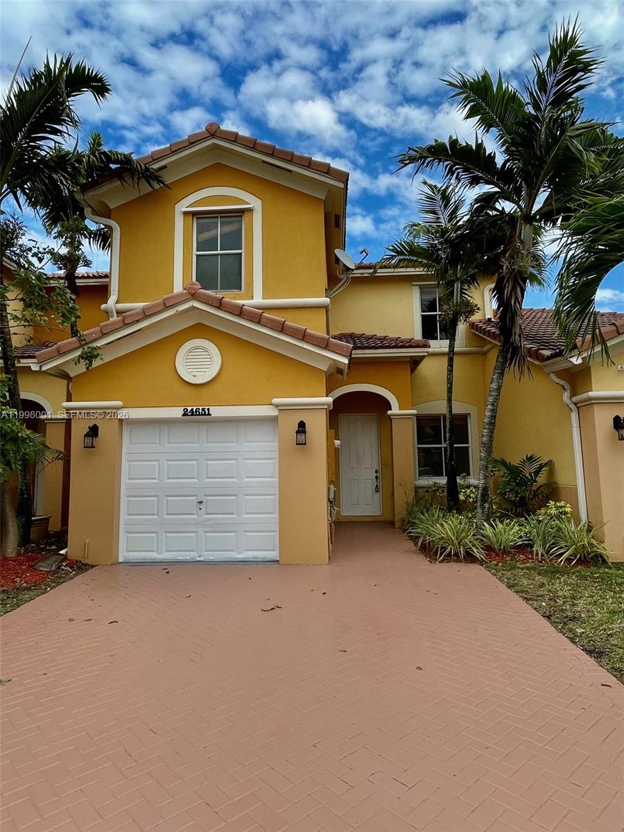 a view of a house with a yard and garage