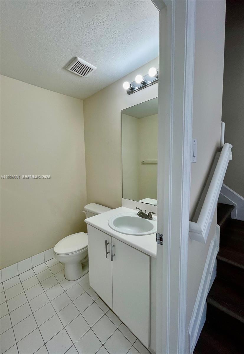 24651 Southwest 110th Avenue Homestead, FL 33032 - Photo 11 of 26 a bathroom with a sink a toilet and a mirror