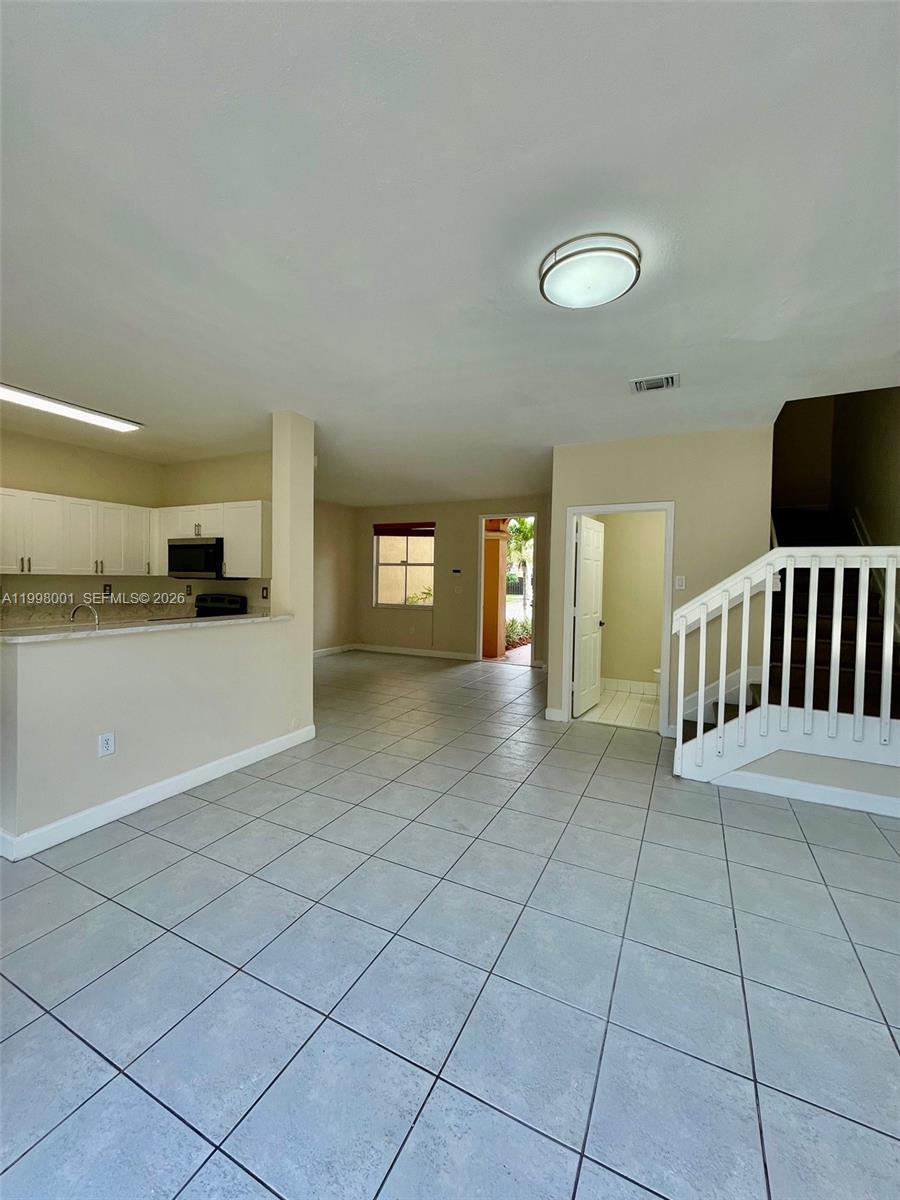 24651 Southwest 110th Avenue Homestead, FL 33032 - Photo 14 of 26 a view of a livingroom with kitchen and furniture