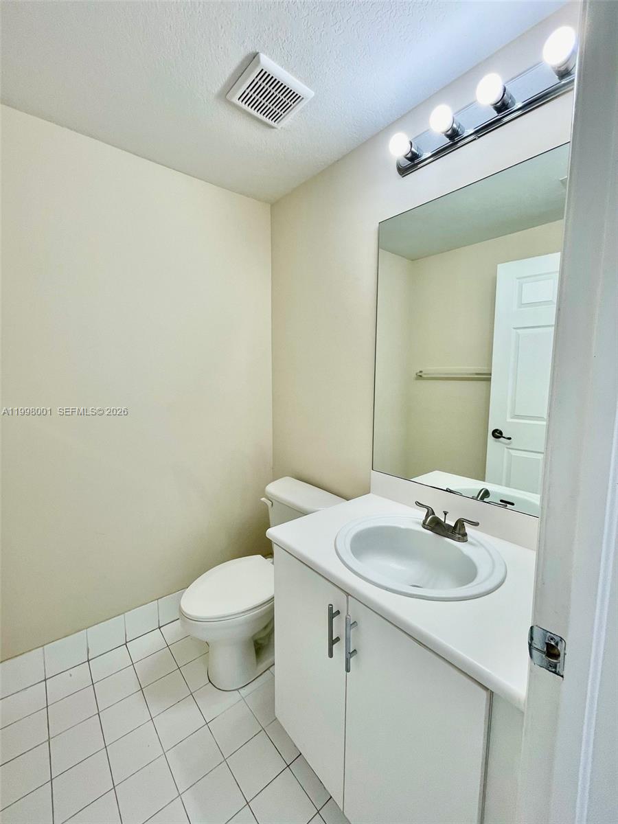 24651 Southwest 110th Avenue Homestead, FL 33032 - Photo 15 of 26 a bathroom with a sink a toilet and mirror
