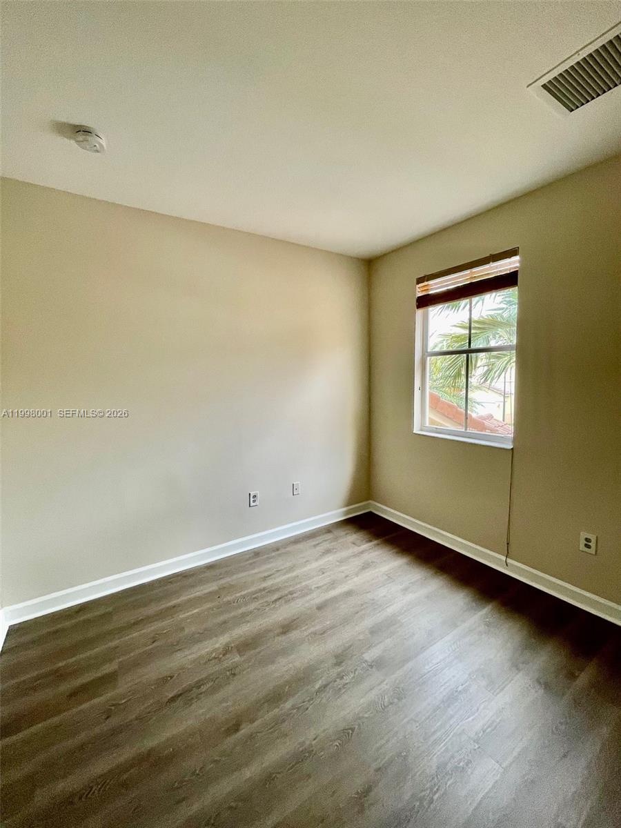 24651 Southwest 110th Avenue Homestead, FL 33032 - Photo 17 of 26 an empty room with wooden floor and windows
