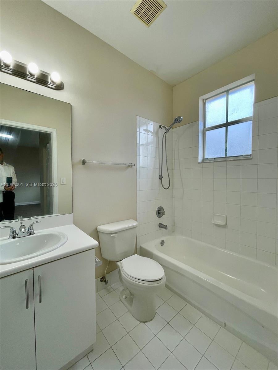 24651 Southwest 110th Avenue Homestead, FL 33032 - Photo 22 of 26 a bathroom with a sink a toilet and a large mirror