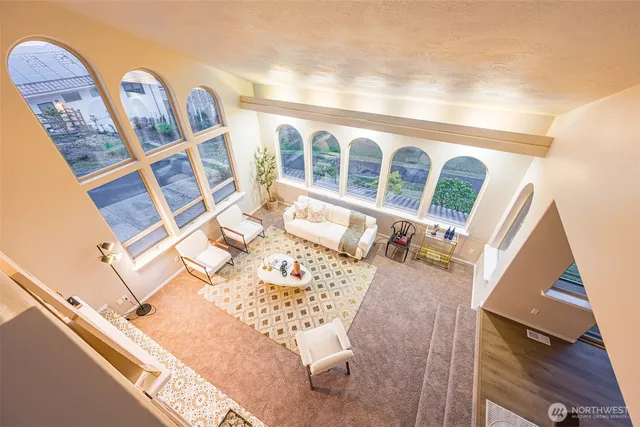 a view of a balcony with wooden floor and furniture