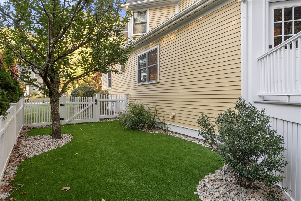 118 Sylvan Road Needham, MA 02492 - Photo 9 of 38 a view of a backyard with plants and a large tree