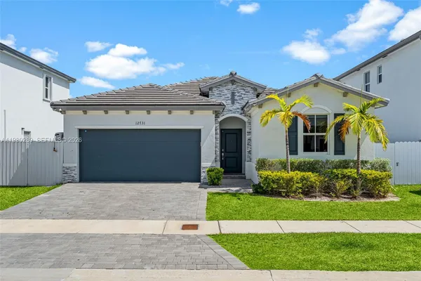 a front view of a house with a yard and garage