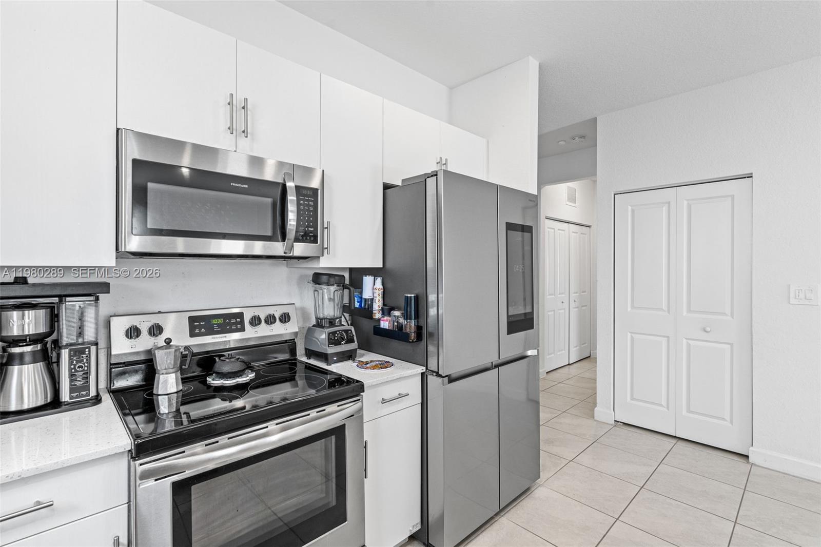 12731 Southwest 213th Street Miami, FL 33177 - Photo 12 of 41 a kitchen with stainless steel appliances granite countertop a refrigerator stove and microwave