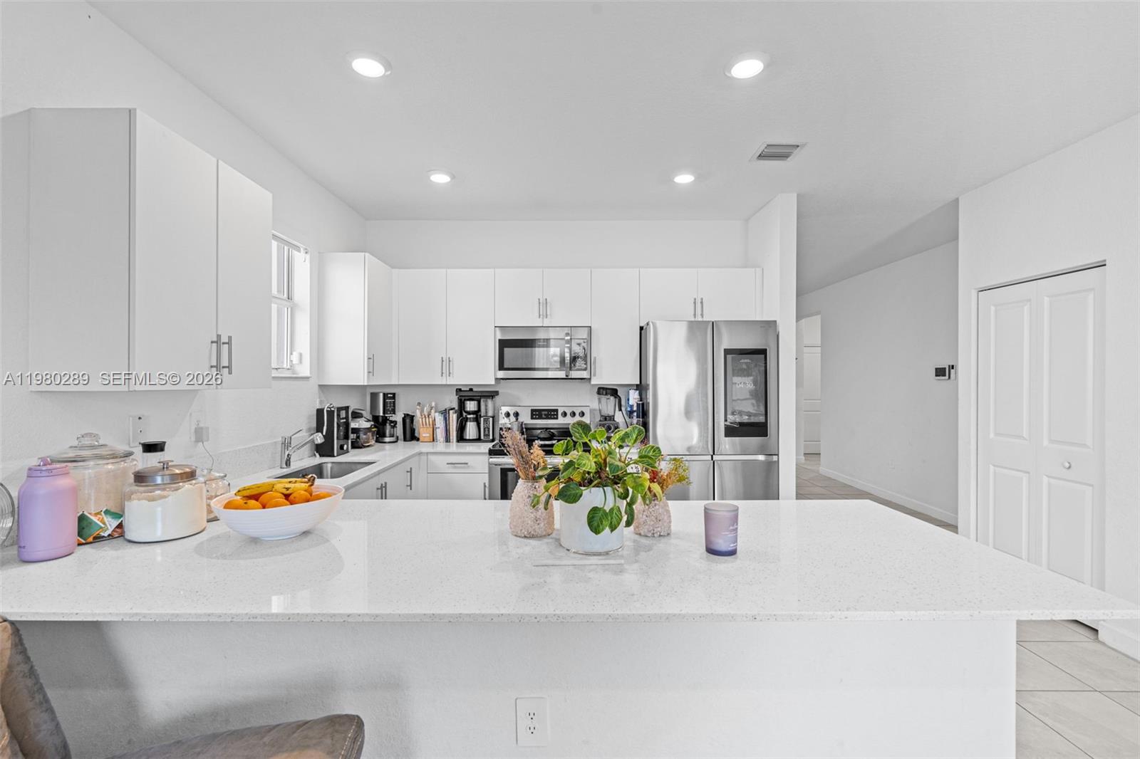 12731 Southwest 213th Street Miami, FL 33177 - Photo 14 of 41 a kitchen with stainless steel appliances granite countertop a sink refrigerator and cabinets