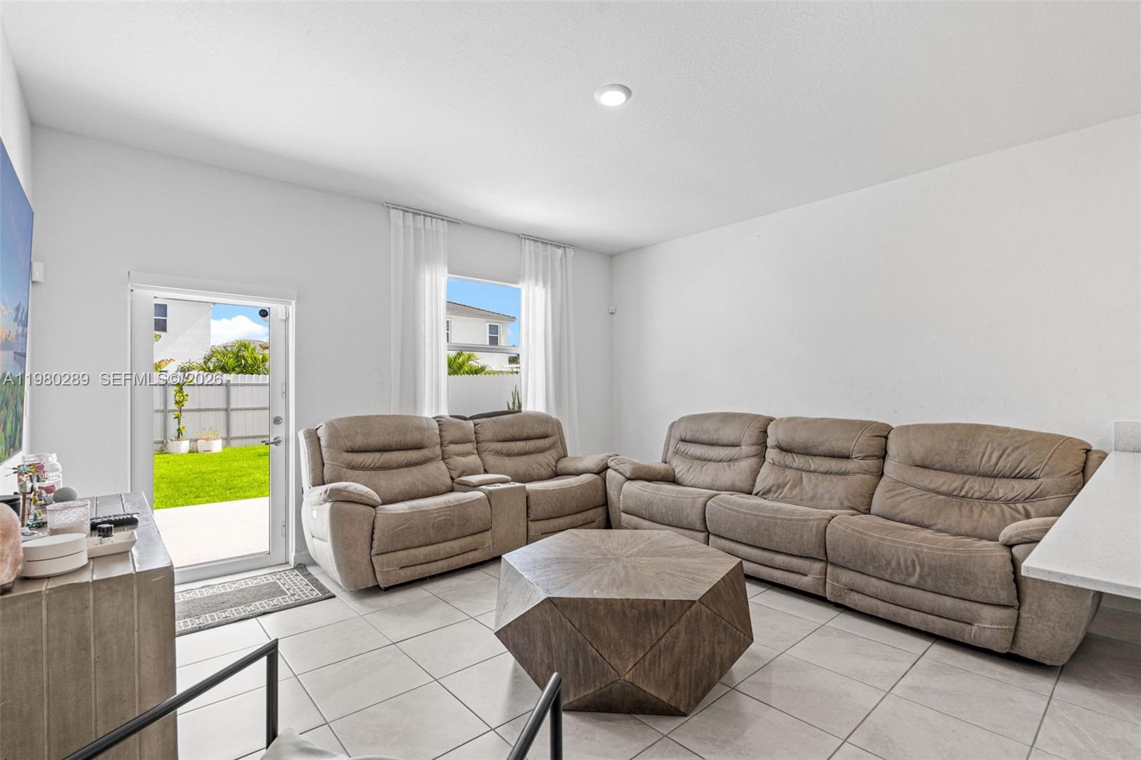 12731 Southwest 213th Street Miami, FL 33177 - Photo 15 of 41 a living room with furniture and a couch