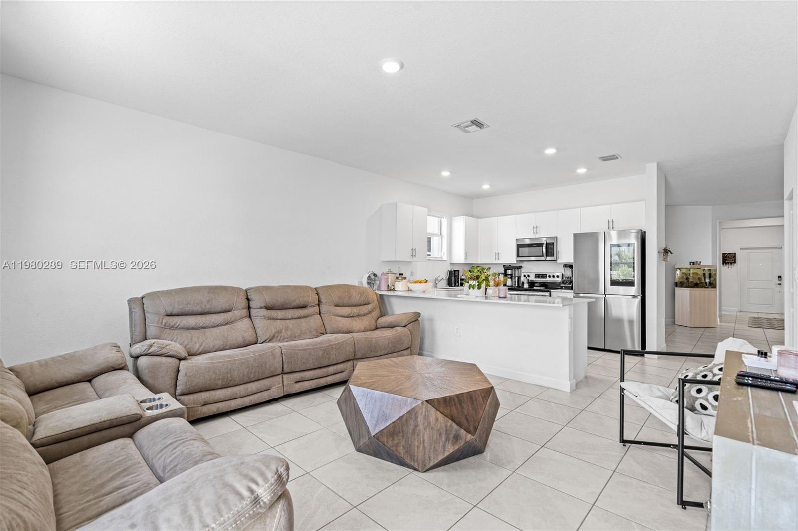 12731 Southwest 213th Street Miami, FL 33177 - Photo 16 of 41 a living room with furniture and kitchen view