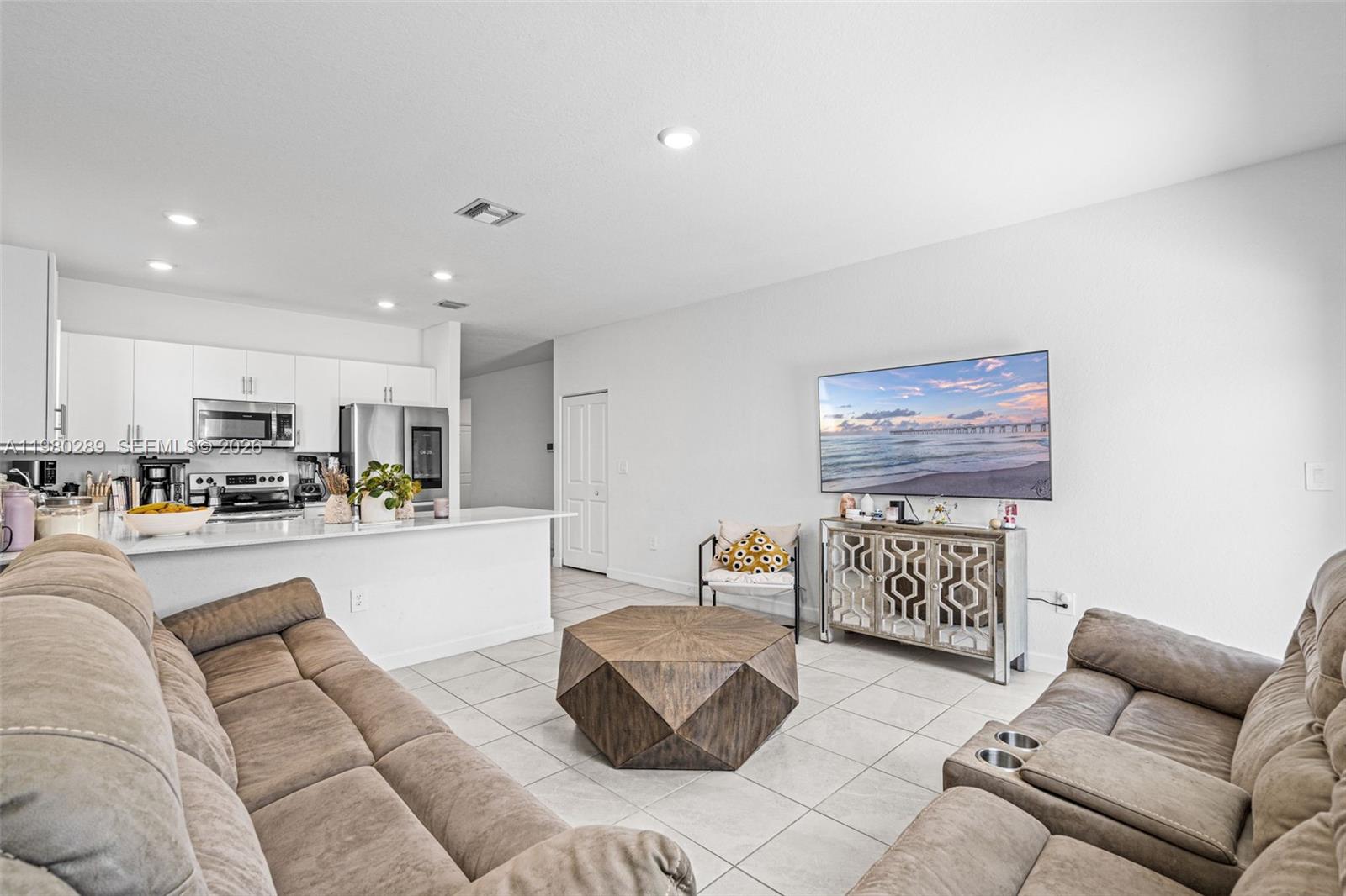 12731 Southwest 213th Street Miami, FL 33177 - Photo 17 of 41 a living room with furniture and kitchen view