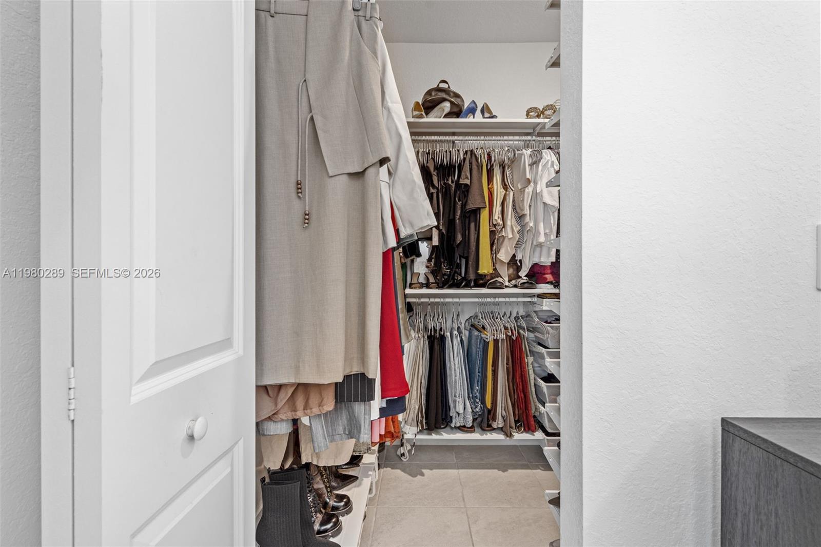 12731 Southwest 213th Street Miami, FL 33177 - Photo 21 of 41 a view of walk in closet with clothes