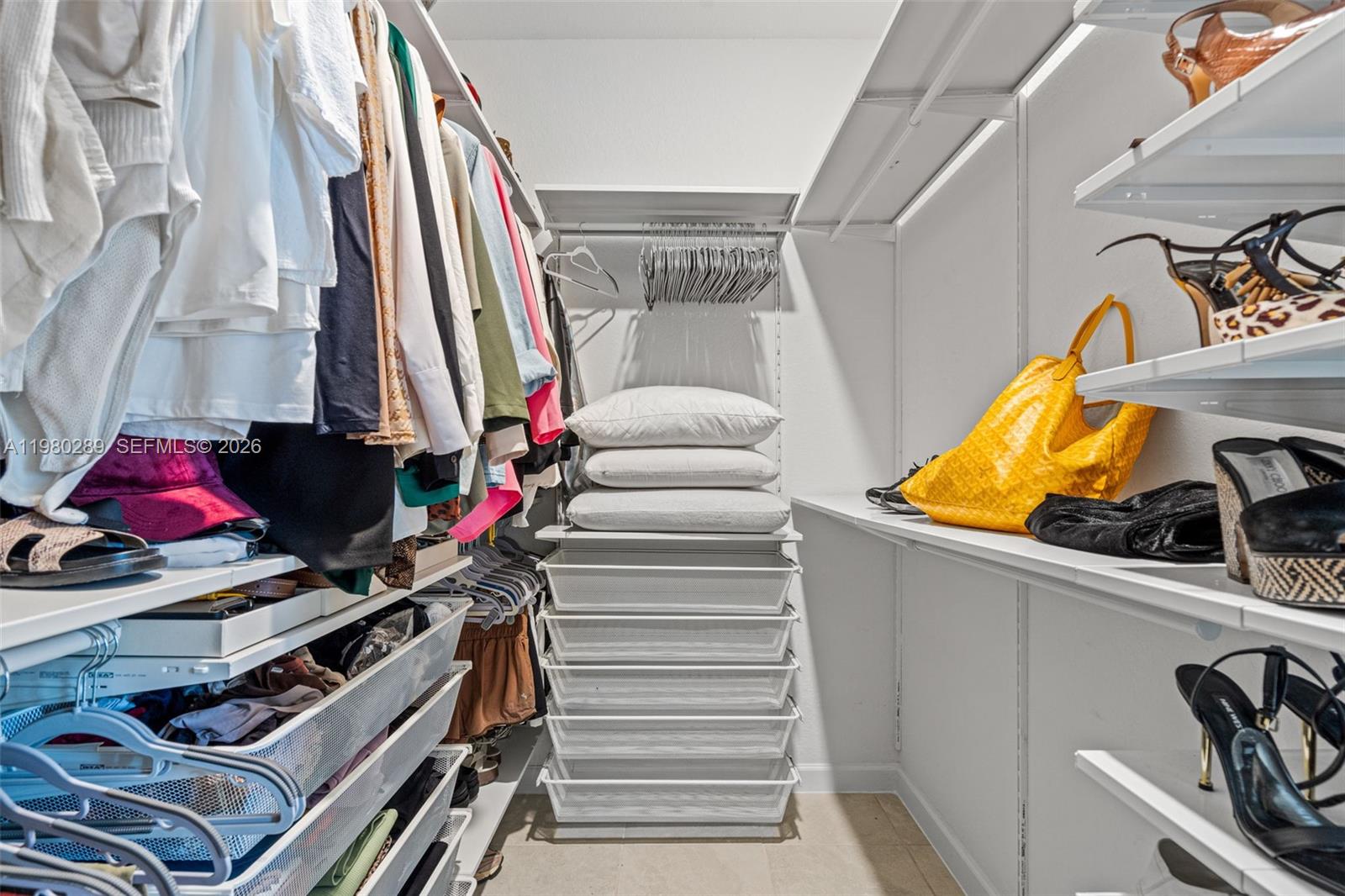 12731 Southwest 213th Street Miami, FL 33177 - Photo 22 of 41 a view of walk in closet with clothes and shoes