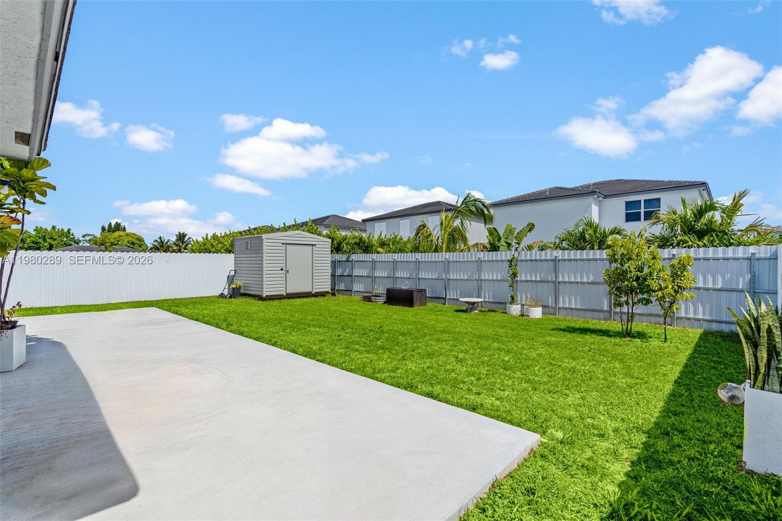 12731 Southwest 213th Street Miami, FL 33177 - Photo 33 of 41 a front view of a house with a yard and garage