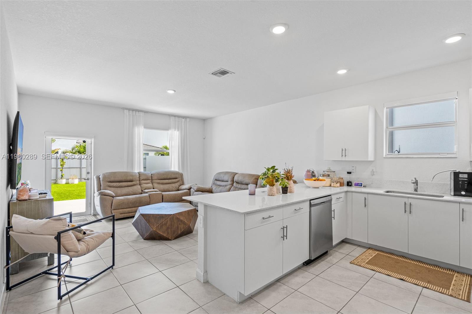 12731 Southwest 213th Street Miami, FL 33177 - Photo 9 of 41 a view of a kitchen with a sink and cabinets