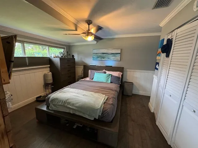 a bedroom with a bed and a mirror