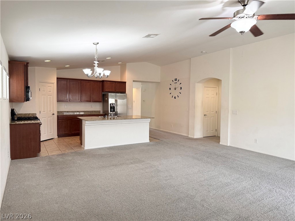8231 Buffalo Ranch Avenue Las Vegas, NV 89147 - Photo 8 of 22 An inviting open-concept living space features a functional kitchen island and warm cabinetry.