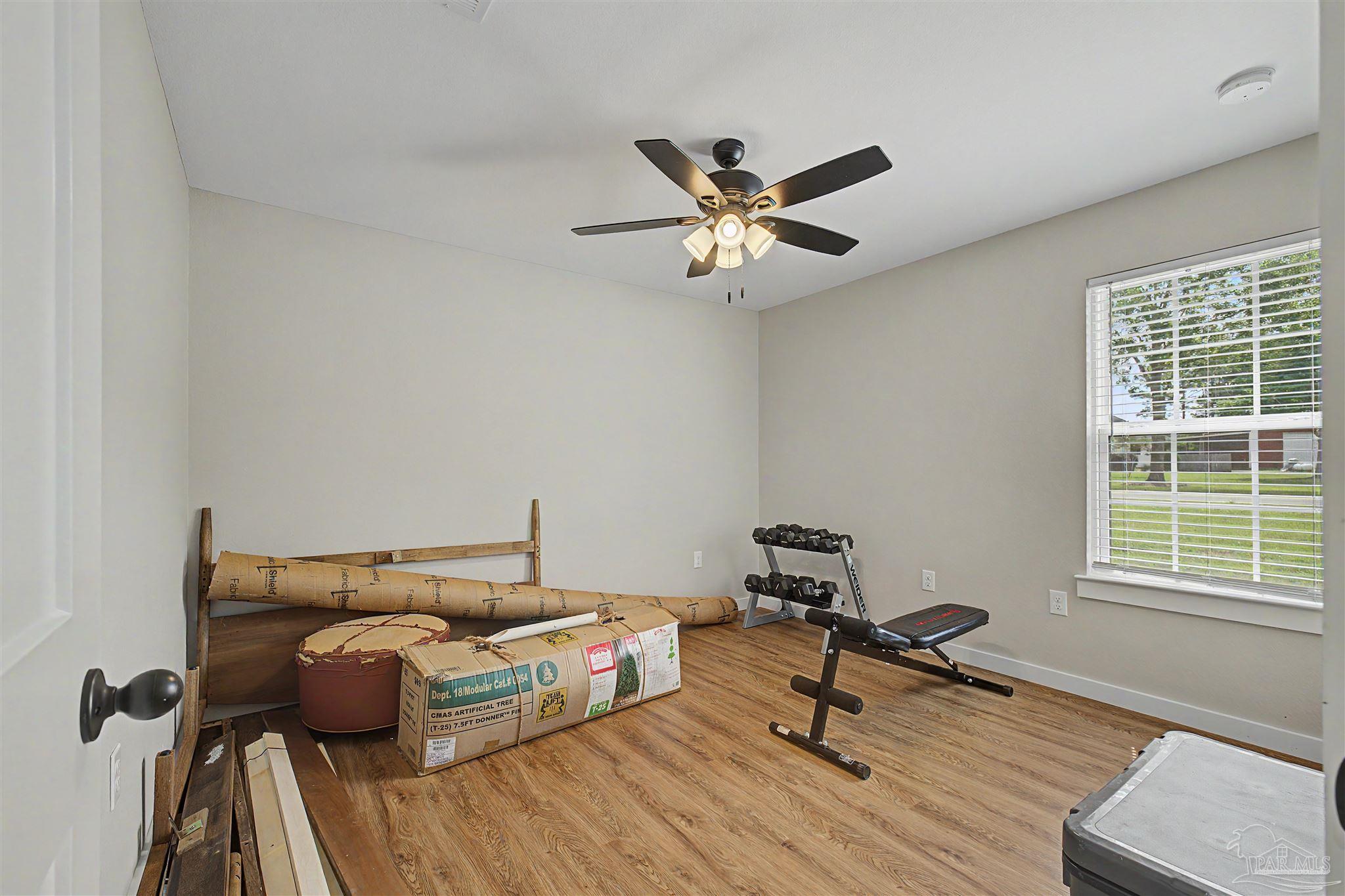 2549 Ten Mile Road Pace, FL 32571 - Photo 26 of 46 a bedroom with furniture and a window