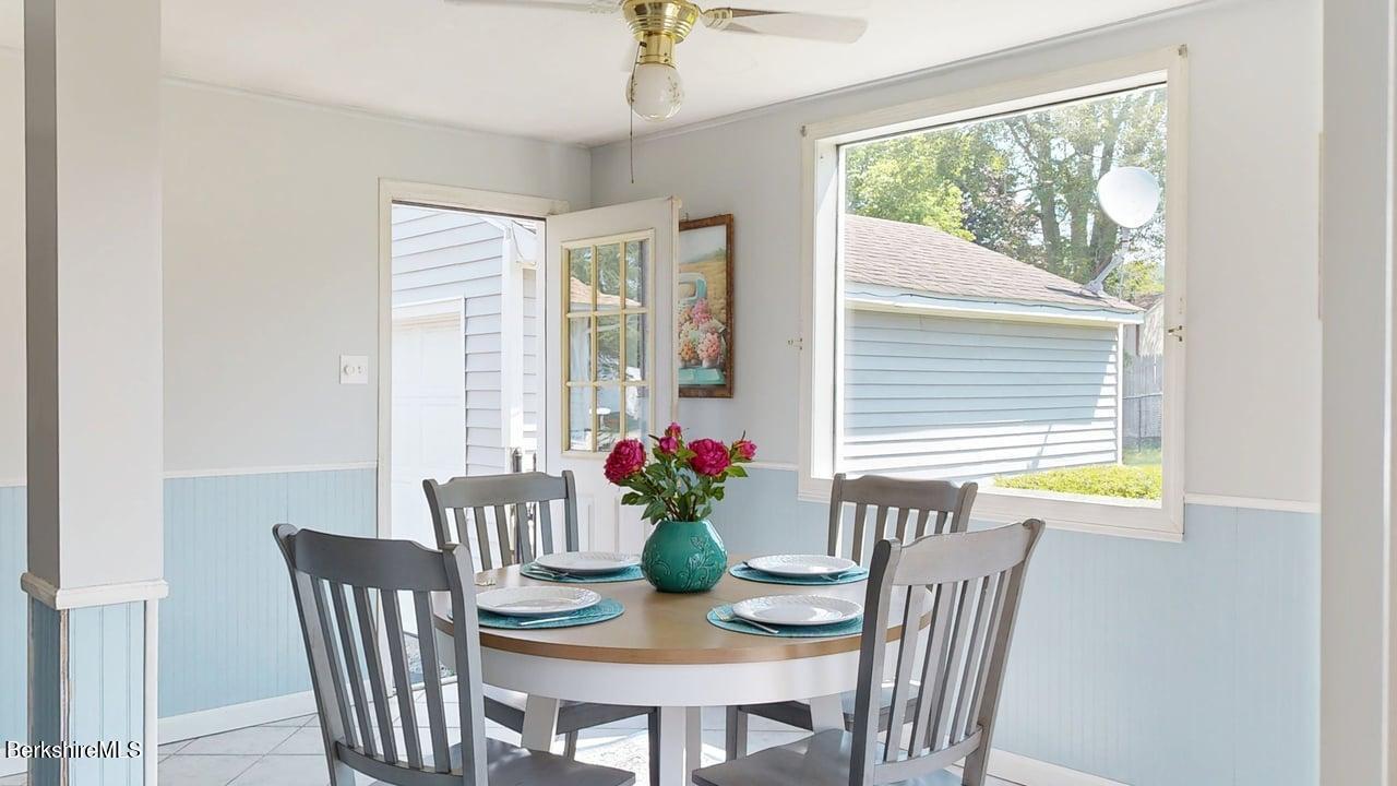 36 Dalton Division Road Dalton, MA 01226 - Photo 14 of 35 a dining room with furniture potted plants and wooden floor