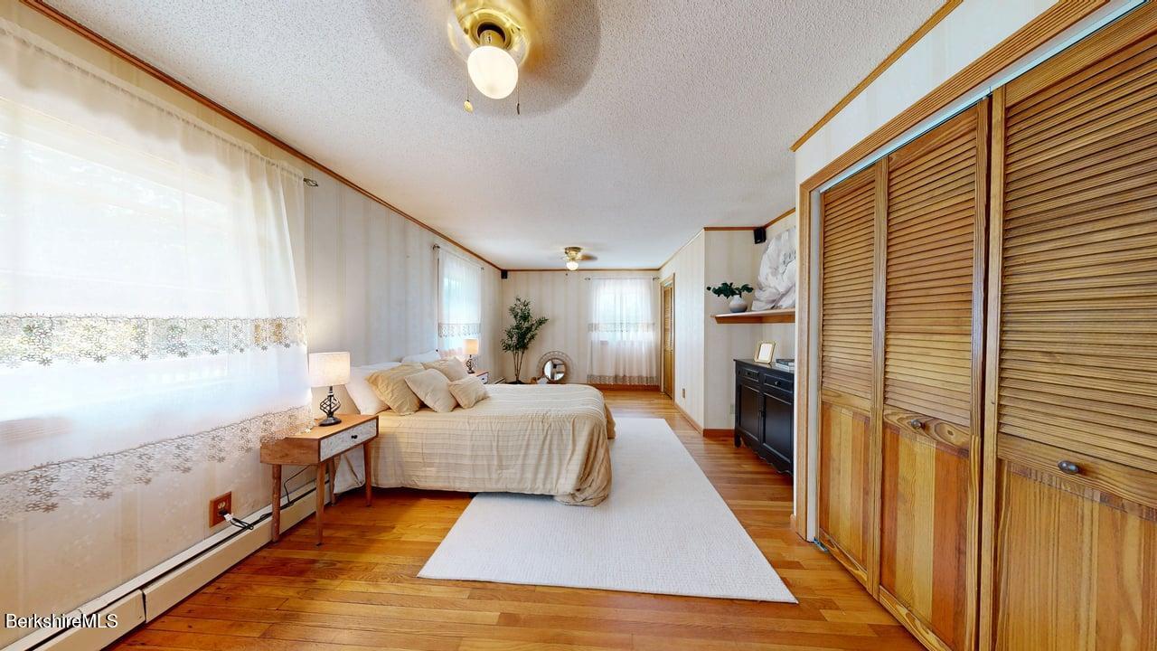 36 Dalton Division Road Dalton, MA 01226 - Photo 23 of 35 a room with a bed and a chandelier