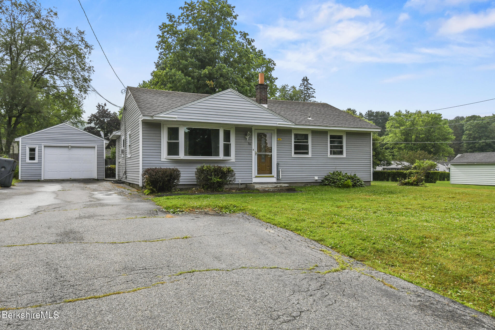 36 Dalton Division Road Dalton, MA 01226 - Photo 3 of 35 a front view of a house with a yard and garage