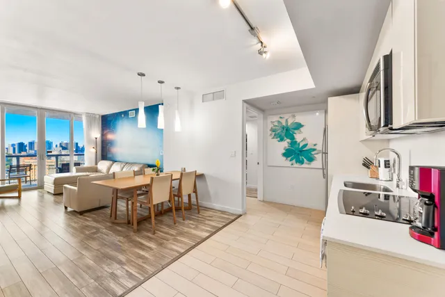 a view of a dining room with furniture and chandelier