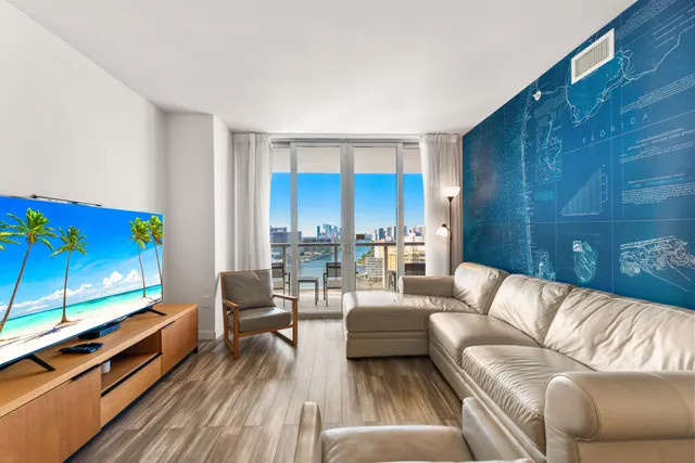 a living room with furniture couches and a flat screen tv