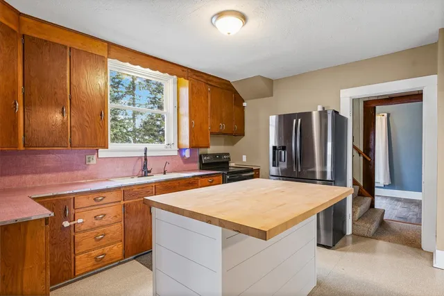 a kitchen with a stove a refrigerator and a sink
