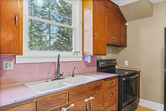 a kitchen with a sink a counter top space and cabinets