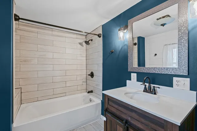 a bathroom with a bathtub and a sink