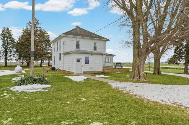 a view of a house with a yard and sitting area