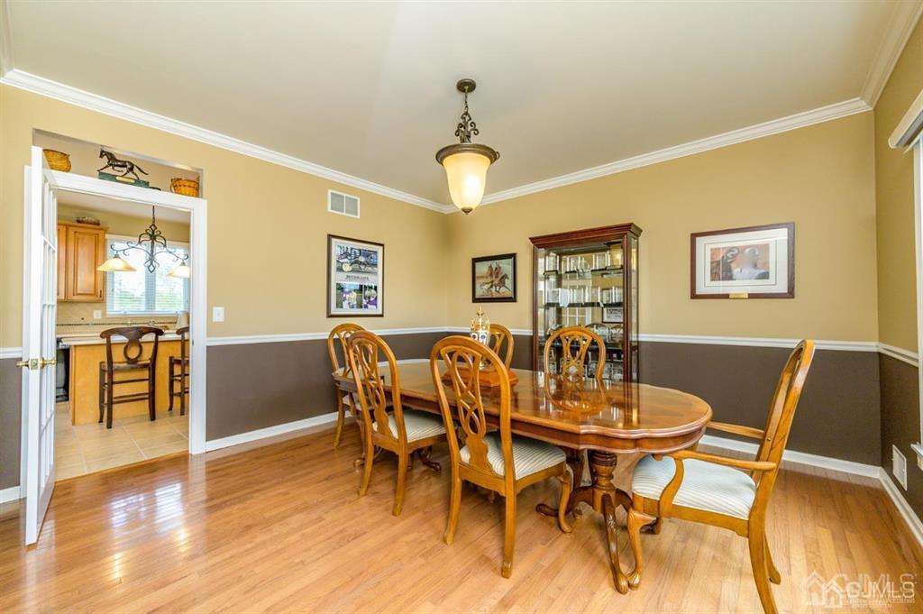 55 Rues Road Cream Ridge, NJ 08514 - Photo 11 of 67 a dining room with wooden floor a chandelier a wooden table and chairs