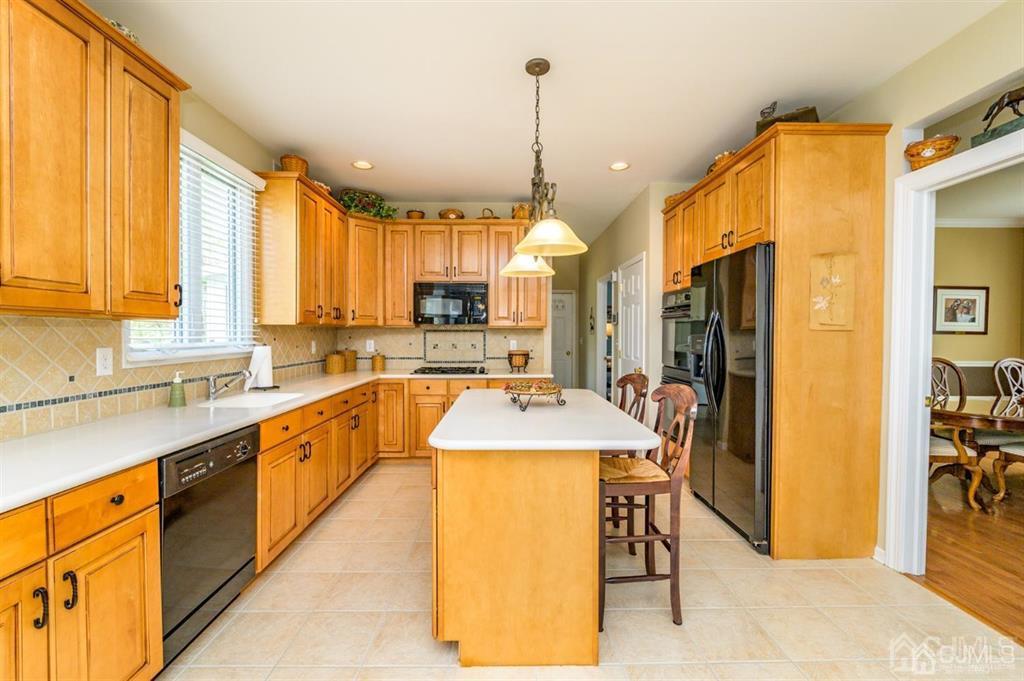 55 Rues Road Cream Ridge, NJ 08514 - Photo 12 of 67 a large kitchen with kitchen island granite countertop a large window cabinets and stainless steel appliances