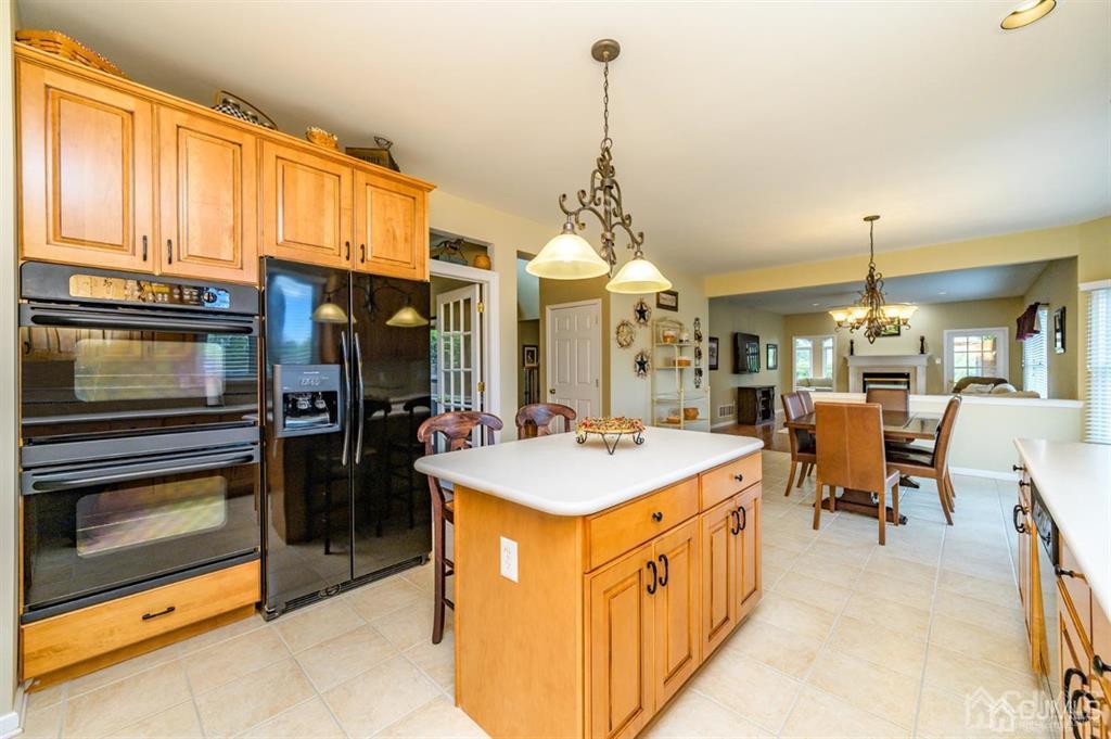 55 Rues Road Cream Ridge, NJ 08514 - Photo 15 of 67 a large kitchen with kitchen island a stove a sink a chimney and a center island