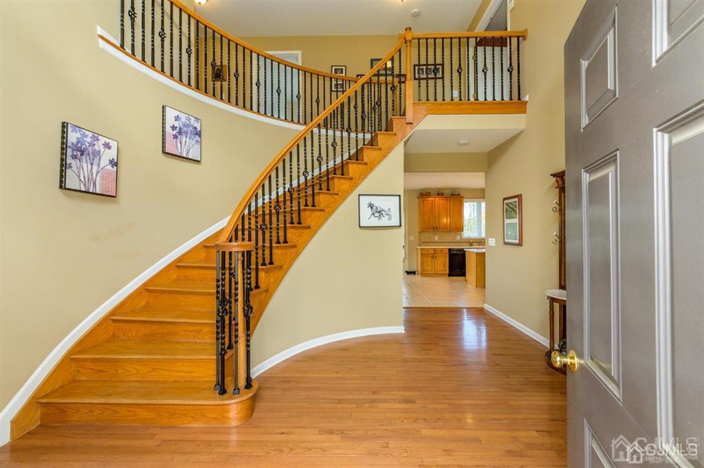 55 Rues Road Cream Ridge, NJ 08514 - Photo 3 of 67 a view of staircase with lots of frames on wall and wooden floor