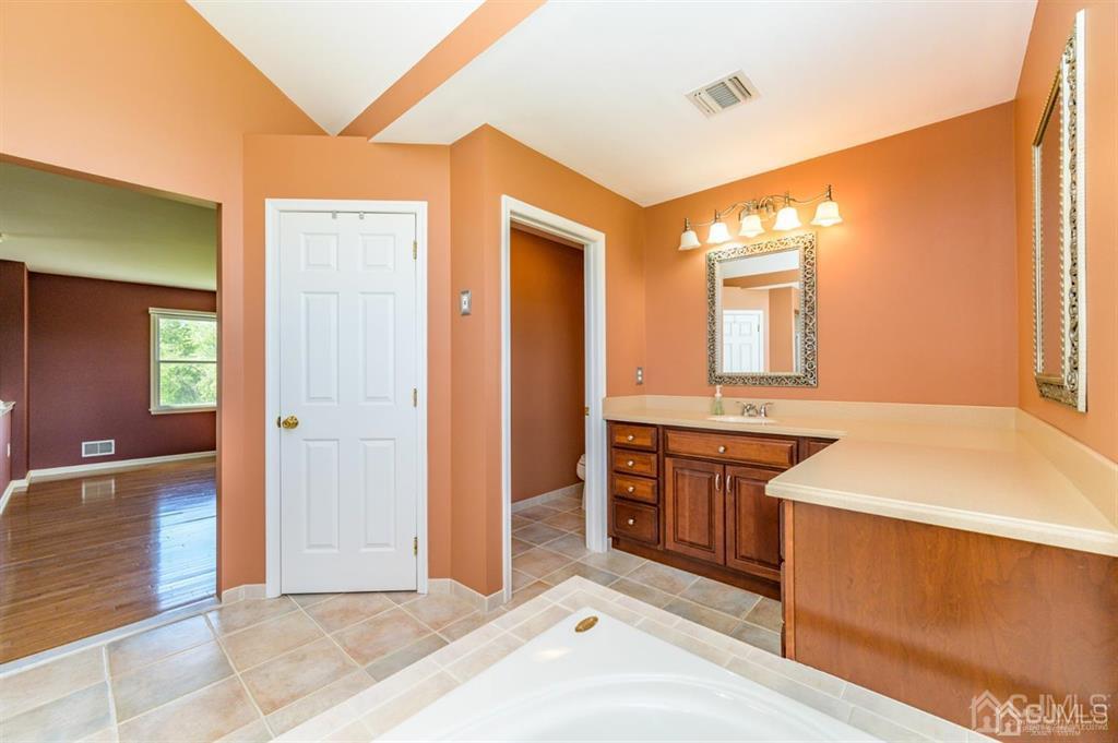 55 Rues Road Cream Ridge, NJ 08514 - Photo 33 of 67 a spacious bathroom with a granite countertop sink and a mirror