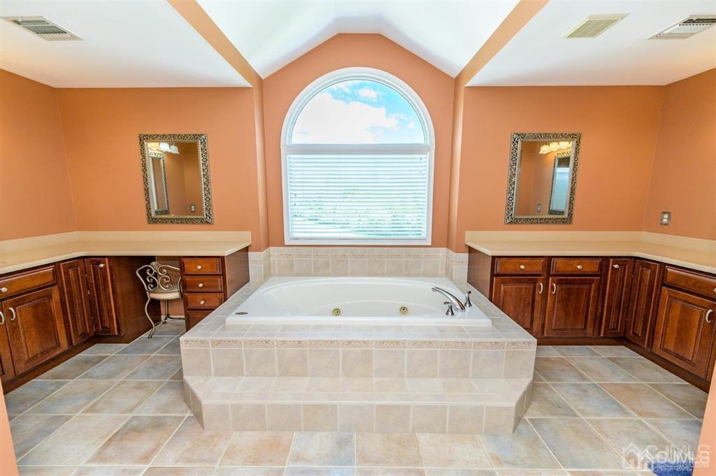 55 Rues Road Cream Ridge, NJ 08514 - Photo 34 of 67 a spacious bathroom with a tub a sink and a large mirror
