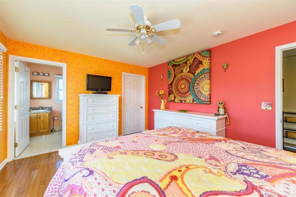 55 Rues Road Cream Ridge, NJ 08514 - Photo 36 of 67 a bedroom with a bed and a chandelier