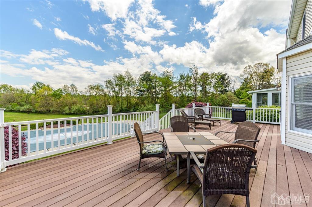 55 Rues Road Cream Ridge, NJ 08514 - Photo 48 of 67 a view of a dinning table and chairs on deck with wooden floor