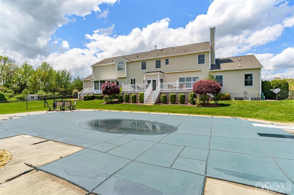 55 Rues Road Cream Ridge, NJ 08514 - Photo 55 of 67 a view of a white house with a big yard and potted plants
