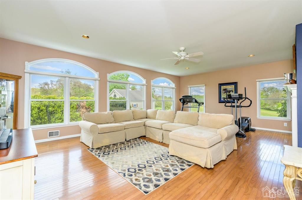 55 Rues Road Cream Ridge, NJ 08514 - Photo 7 of 67 a living room with furniture large windows and wooden floor
