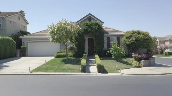 a view of a house with a yard and plants