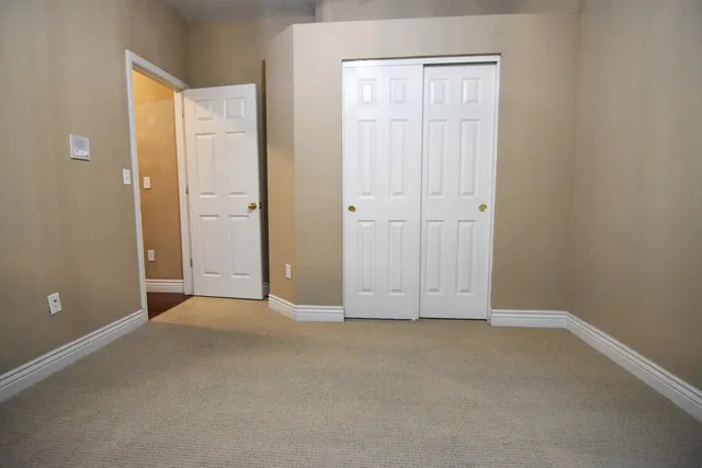 an empty room with closet area
