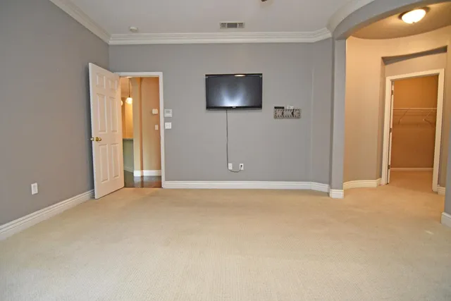 an empty room with windows and closet