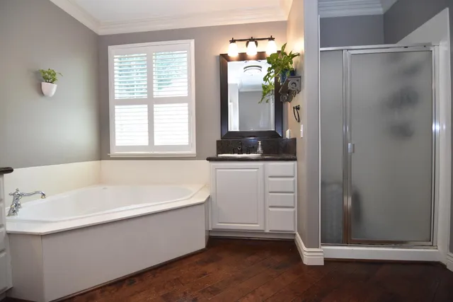 a white bath tub sitting in a bathroom next to a window