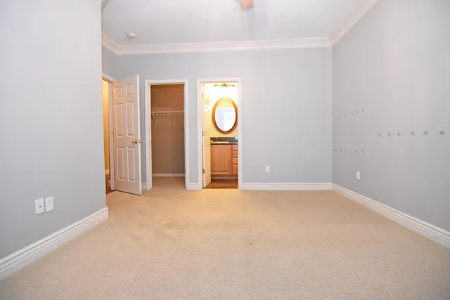 a view of an empty room with a window and a fan