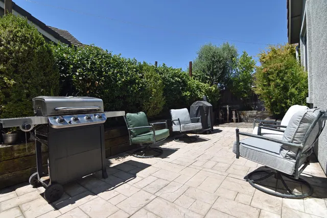 a view of a patio with a dining table and chairs with a fire pit