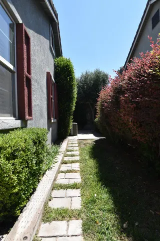 a front view of a house with a garden