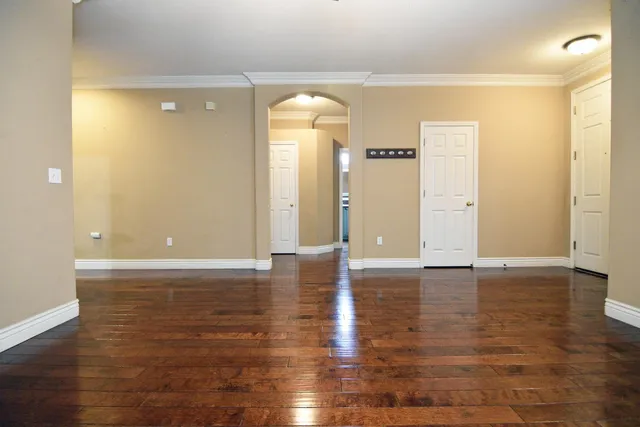 a view of a room with wooden floor