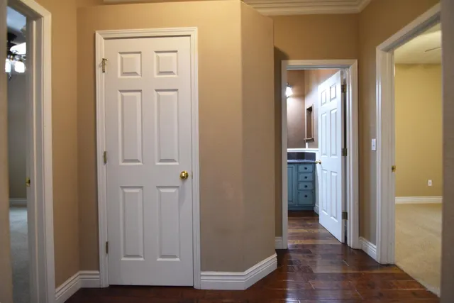a view of a hallway with wooden floor