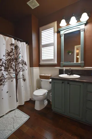 a bathroom with a toilet sink and mirror